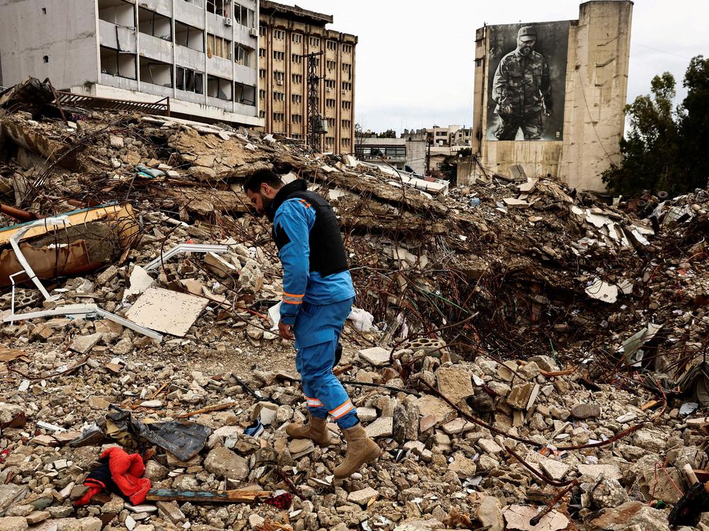 A paramedic walks among the rubble at a site damaged in an Israeli strike, amid escalating hostilities between Israel and Hezbollah, as the U.S.-Israeli conflict with Iran continues, in Nabatieh, Lebanon, March 25, 2026. REUTERS/Yara Nardi