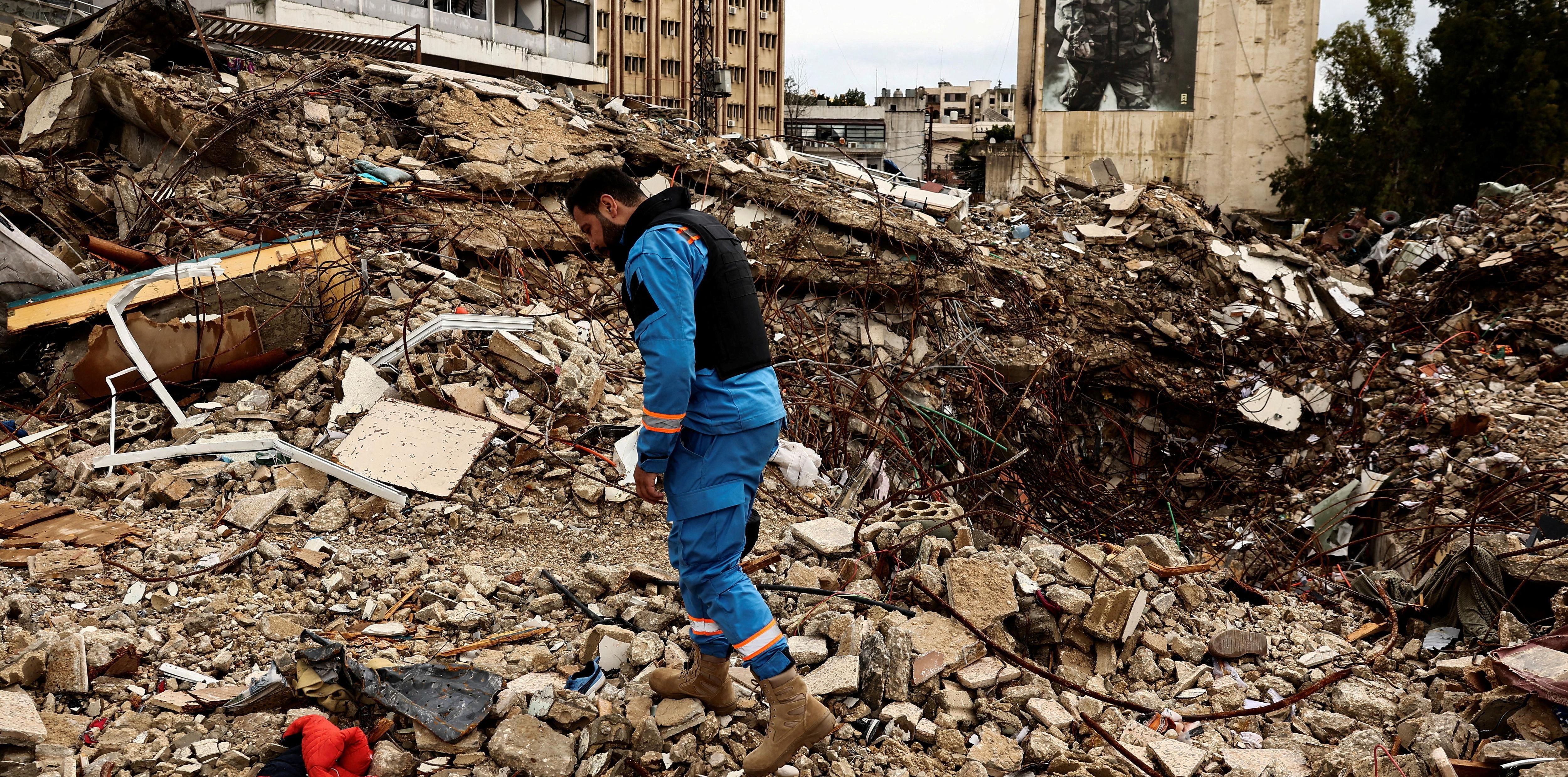 A paramedic walks among the rubble at a site damaged in an Israeli strike, amid escalating hostilities between Israel and Hezbollah, as the U.S.-Israeli conflict with Iran continues, in Nabatieh, Lebanon, March 25, 2026. REUTERS/Yara Nardi