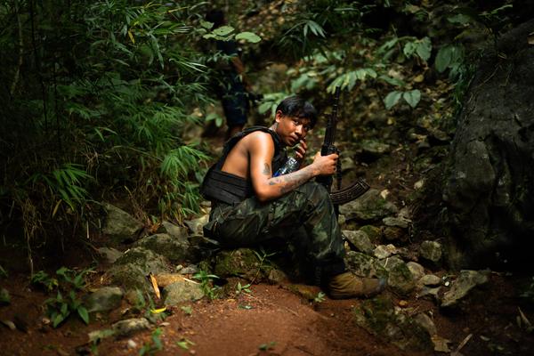 A soldier from Alpha Team 01, affiliated with the National Unity Government, rests during a reconnaissance mission