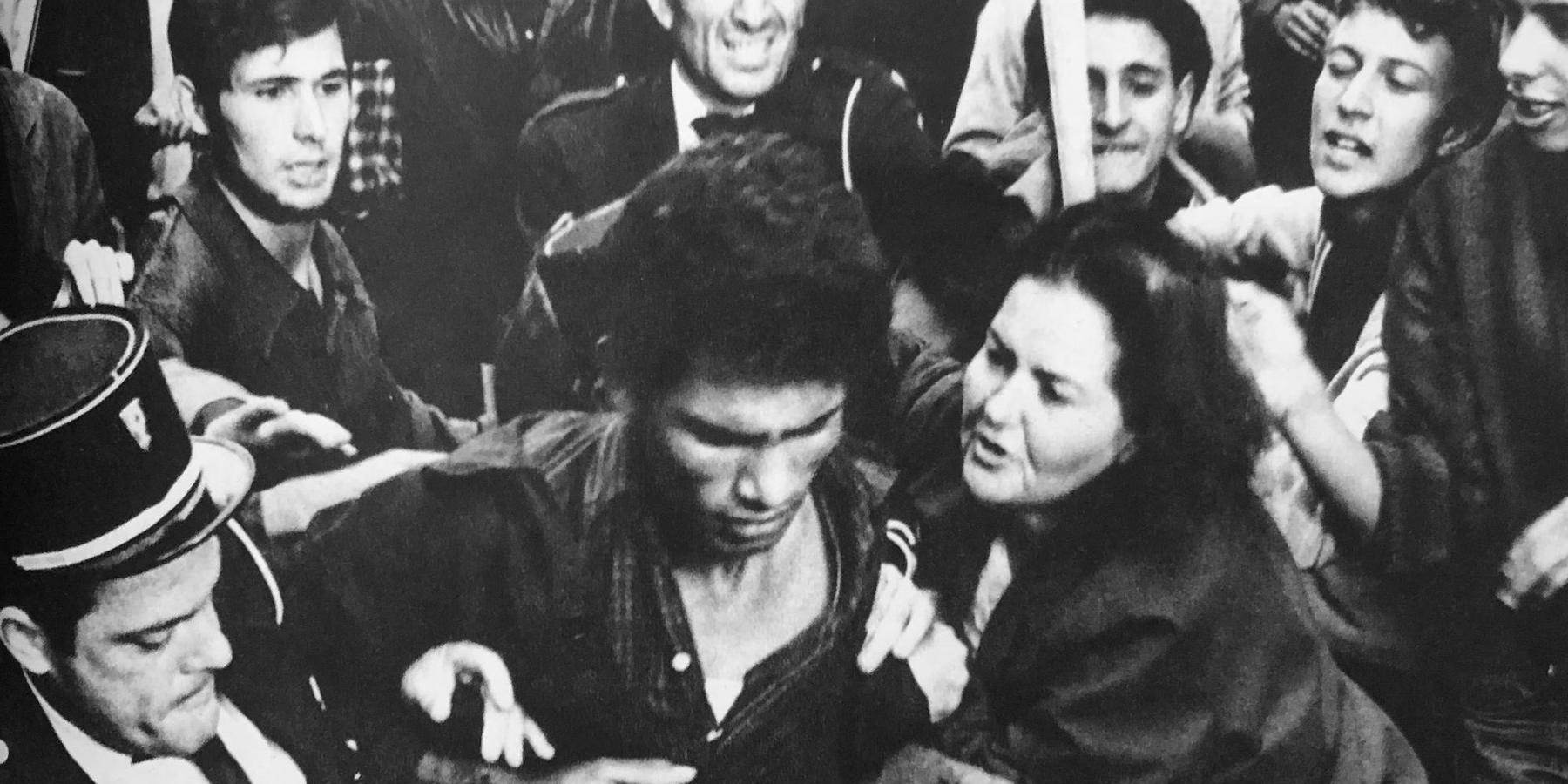 A still from 'The Battle of Algiers,' in which French authorities arrest an apparent FLN fighter in a crowd