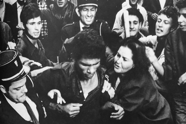A still from 'The Battle of Algiers,' in which French authorities arrest an apparent FLN fighter in a crowd