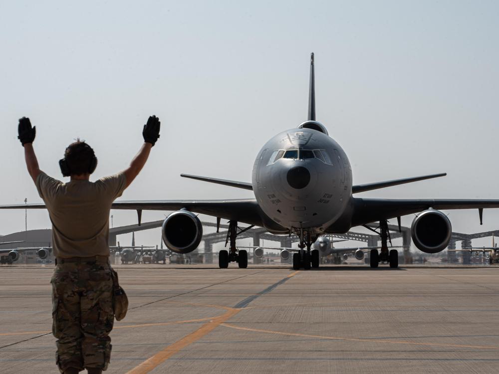 A U.S. Airman from the 378th Expeditionary Aircraft Maintenance Squadron directs a taxiing KC-10 Extender assigned to the 908th Air Refueling Squadron after the aircraft returned from the airframe's final combat sortie on Prince Sultan Air Base, Oct. 3, 2023