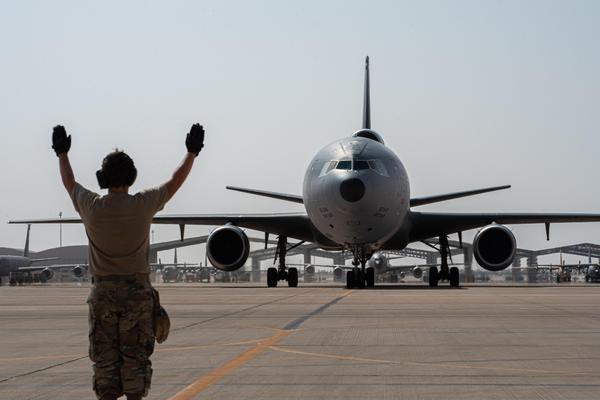 A U.S. Airman from the 378th Expeditionary Aircraft Maintenance Squadron directs a taxiing KC-10 Extender assigned to the 908th Air Refueling Squadron after the aircraft returned from the airframe's final combat sortie on Prince Sultan Air Base, Oct. 3, 2023