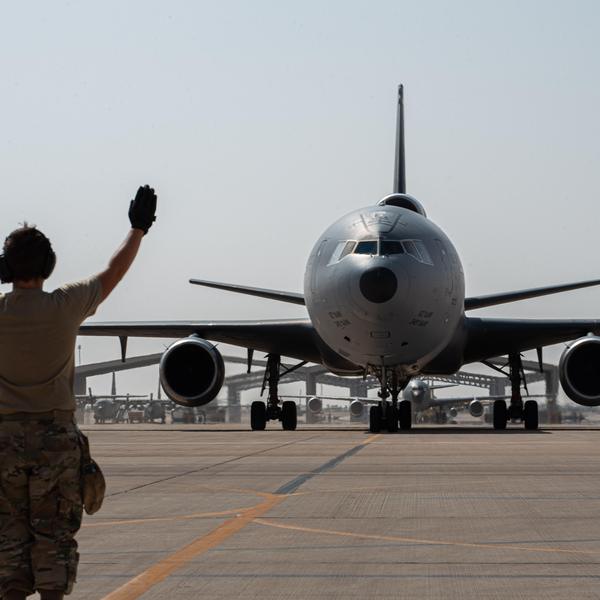 A U.S. Airman from the 378th Expeditionary Aircraft Maintenance Squadron directs a taxiing KC-10 Extender assigned to the 908th Air Refueling Squadron after the aircraft returned from the airframe's final combat sortie on Prince Sultan Air Base, Oct. 3, 2023
