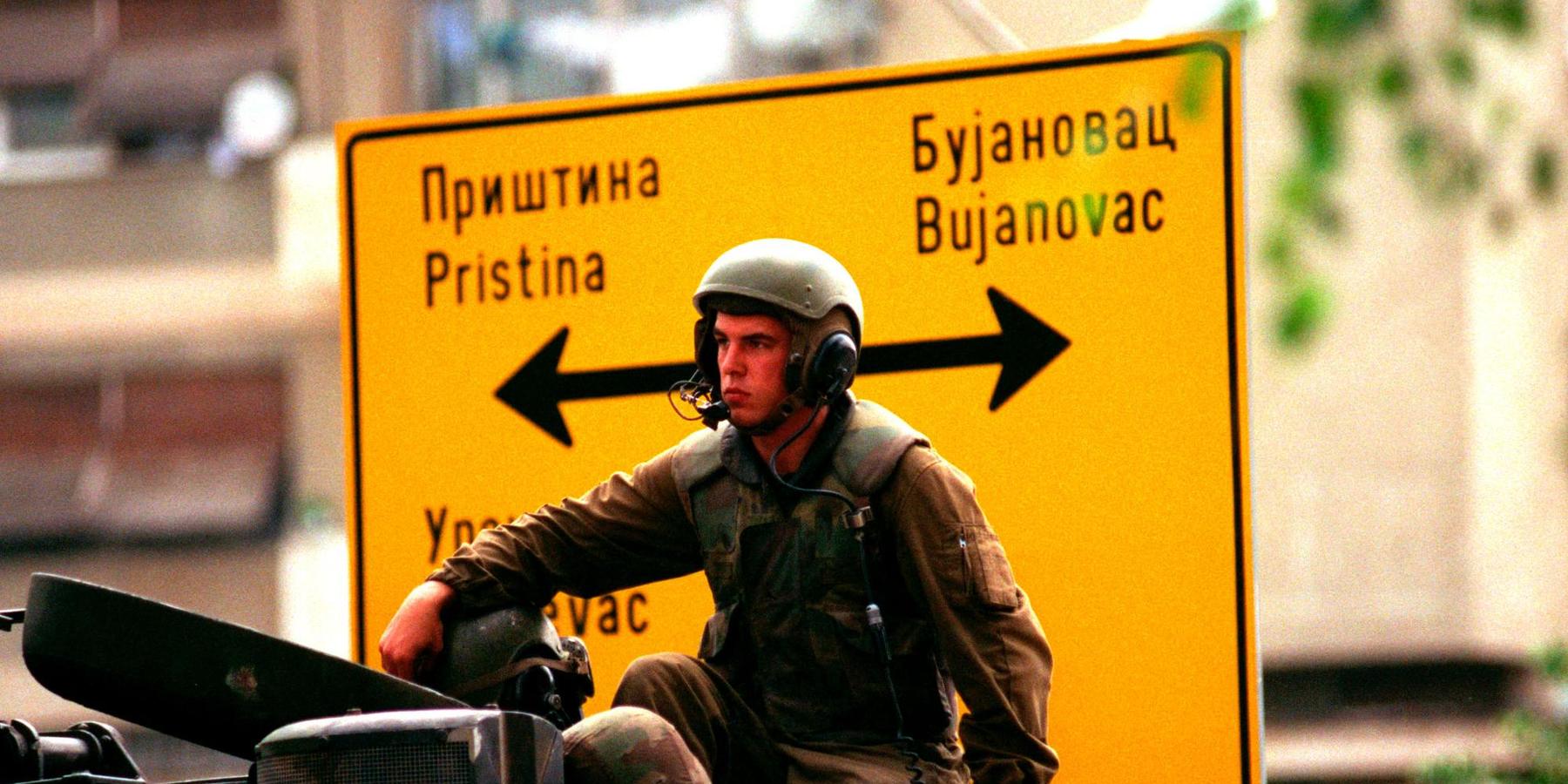 A US marine sits on an amphibious vehicle as he waits in Gnijlane, Kosovo, on July 1, 1999