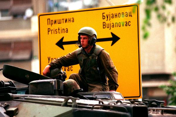 A US marine sits on an amphibious vehicle as he waits in Gnijlane, Kosovo, on July 1, 1999