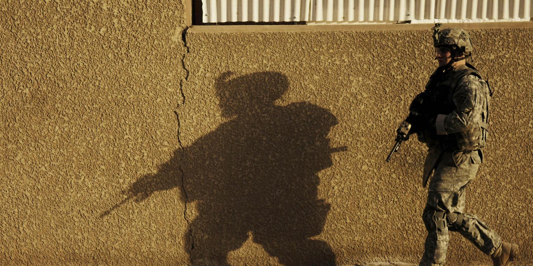 A US soldier walks through the street in Baghdad
