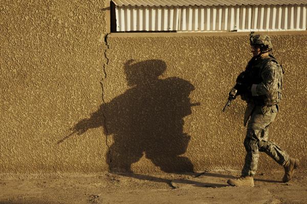 A US soldier walks through the street in Baghdad