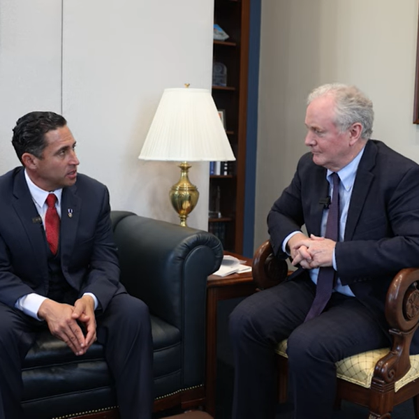 Former GHF contractor Anthony Aguilar and Sen. Chris Van Hollen (D.-Md)