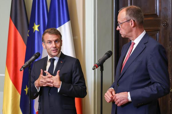 French President Emmanuel Macron participates in a press conference alongside German Chancellor Friedrich Merz