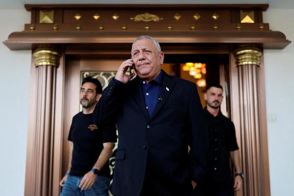 Gadi Eisenkot speaks on a phone outside a conference for his campaign ahead of Israeli elections