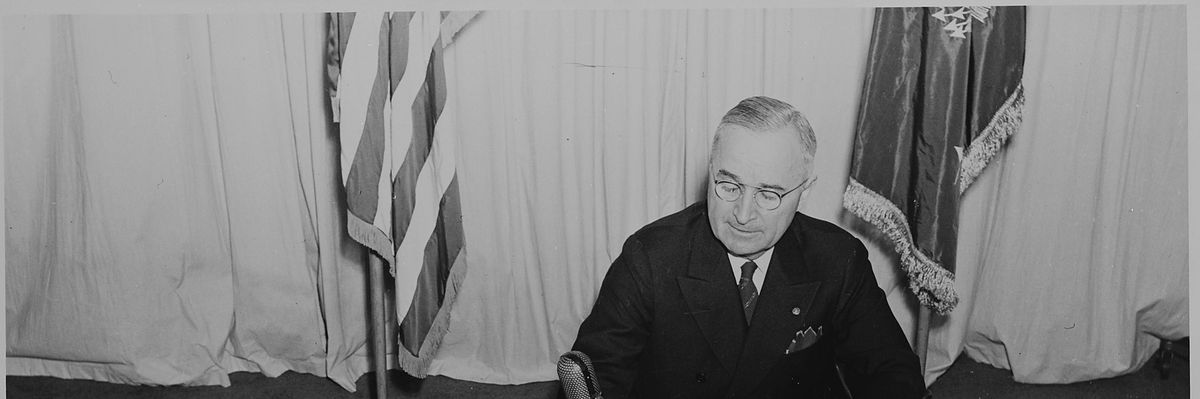Lossy-page1-2560px-president_harry_s._truman_seated_at_a_desk_before_a_microphone_announcing_the_end_of_world_war_ii_in_europe._a..._-_nara_-_199076.tif