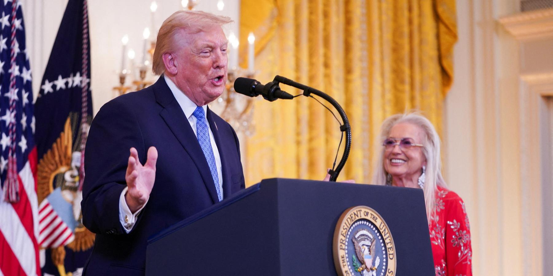 Miriam Adelson looks on as U.S. President Donald Trump speaks at a Hanukkah reception in the East Room of the White House