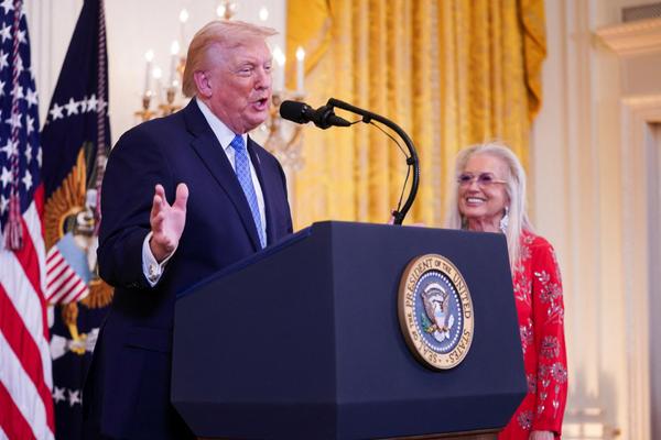Miriam Adelson looks on as U.S. President Donald Trump speaks at a Hanukkah reception in the East Room of the White House