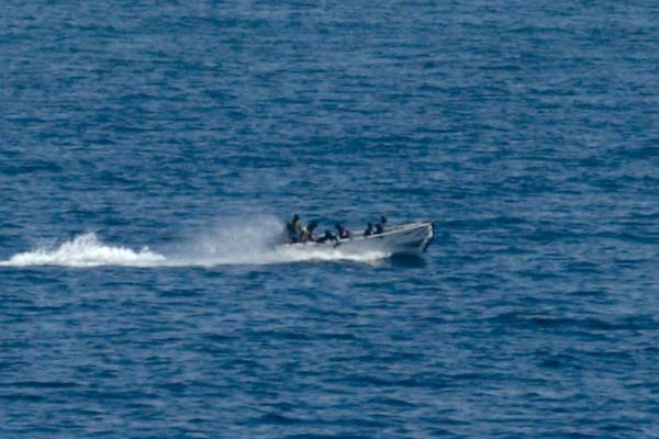 Pirates holding the MV Faina conduct resupply while under observation by a U.S. Navy ship off the Somali coast on Oct 5, 2008