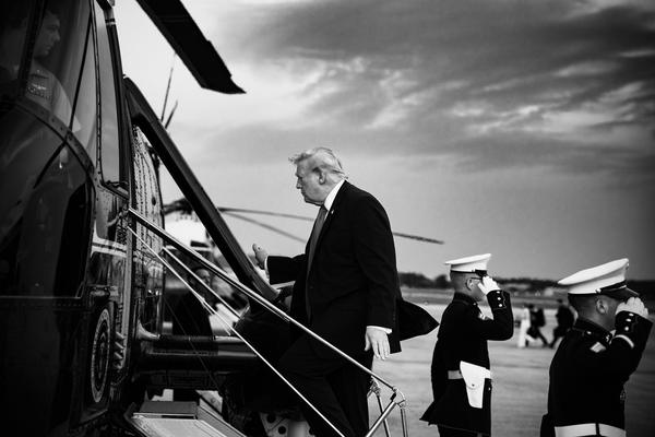 President Donal Trump boards a helicopter