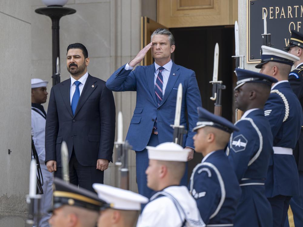 Secretary of Defense Pete Hegseth and Iraqi Prime Minister Ali al-Zaidi stand for the playing of the U.S. and Iraqi national anthems prior to a bilateral meeting at the Pentagon