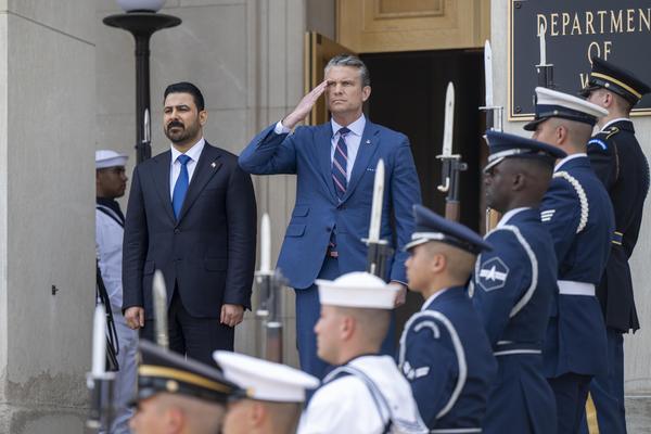 Secretary of Defense Pete Hegseth and Iraqi Prime Minister Ali al-Zaidi stand for the playing of the U.S. and Iraqi national anthems prior to a bilateral meeting at the Pentagon