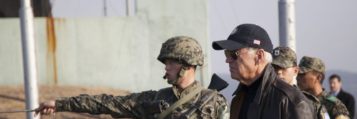 South_korean_army_1st_lt._choi_min_kyu_left_points_across_the_border_into_north_korea_while_briefing_u.s._vice_president_joe_biden-scaled
