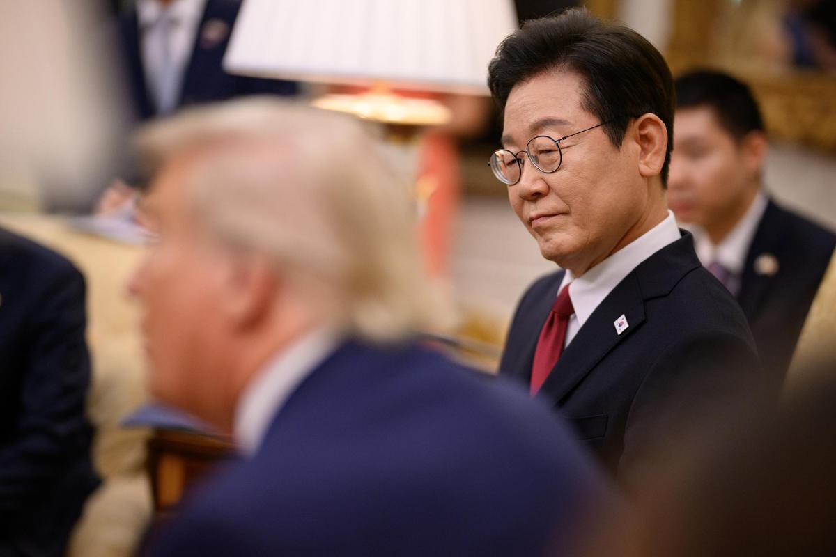 South Korean President Lee Jae-Myung looks on as President Donald Trump speaks during a meeting in the Oval Office.