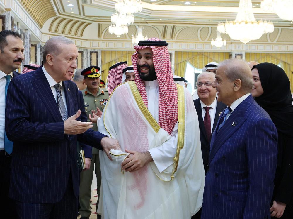 Turkish President Recep Tayyip Erdogan, Saudi Crown Prince Mohammed bin Salman and Pakistan's Prime Minister Shehbaz Sharif chat after signing a joint defense agreement in Mecca, Saudi Arabia