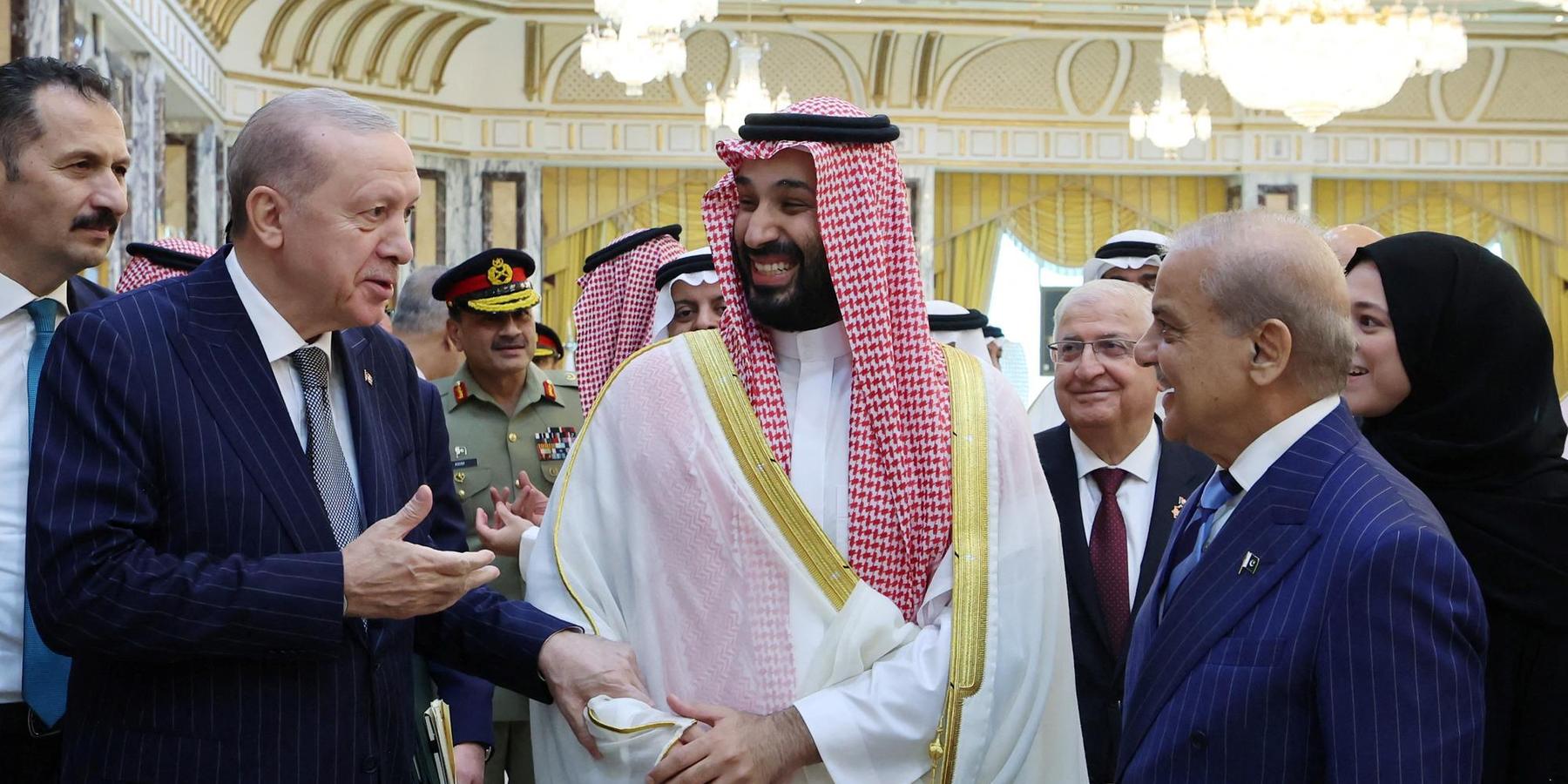 Turkish President Recep Tayyip Erdogan, Saudi Crown Prince Mohammed bin Salman and Pakistan's Prime Minister Shehbaz Sharif chat after signing a joint defense agreement in Mecca, Saudi Arabia