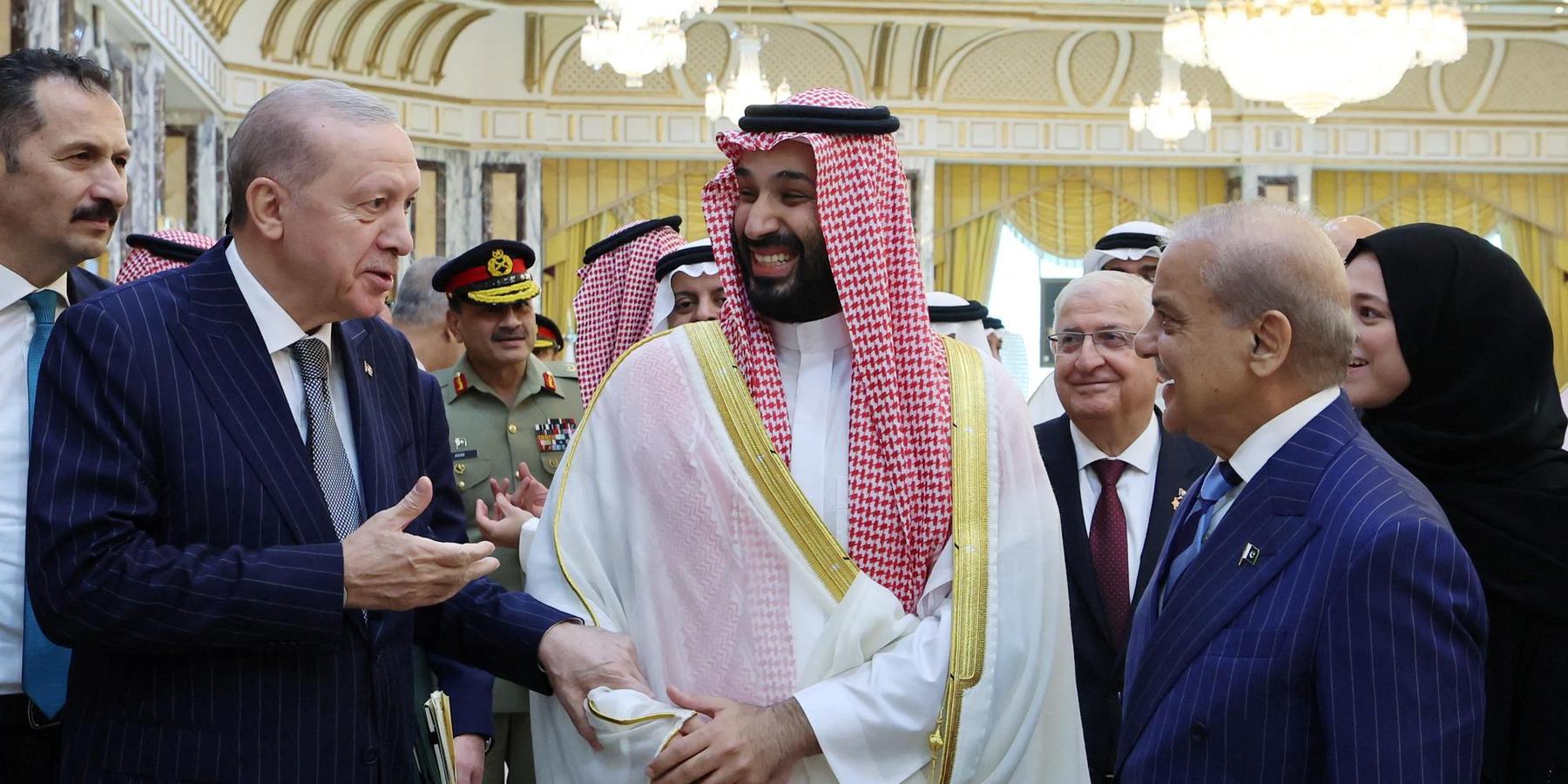 Turkish President Recep Tayyip Erdogan, Saudi Crown Prince Mohammed bin Salman and Pakistan's Prime Minister Shehbaz Sharif chat after signing a joint defense agreement in Mecca, Saudi Arabia