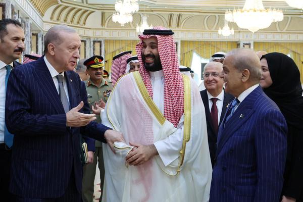 Turkish President Recep Tayyip Erdogan, Saudi Crown Prince Mohammed bin Salman and Pakistan's Prime Minister Shehbaz Sharif chat after signing a joint defense agreement in Mecca, Saudi Arabia