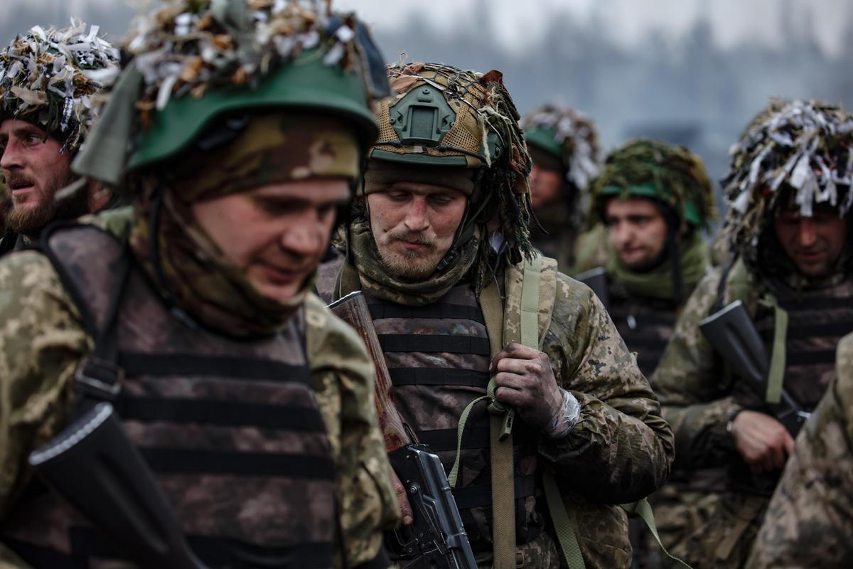 Ukrainian soldiers walk together during training for the 2023 counteroffensive.