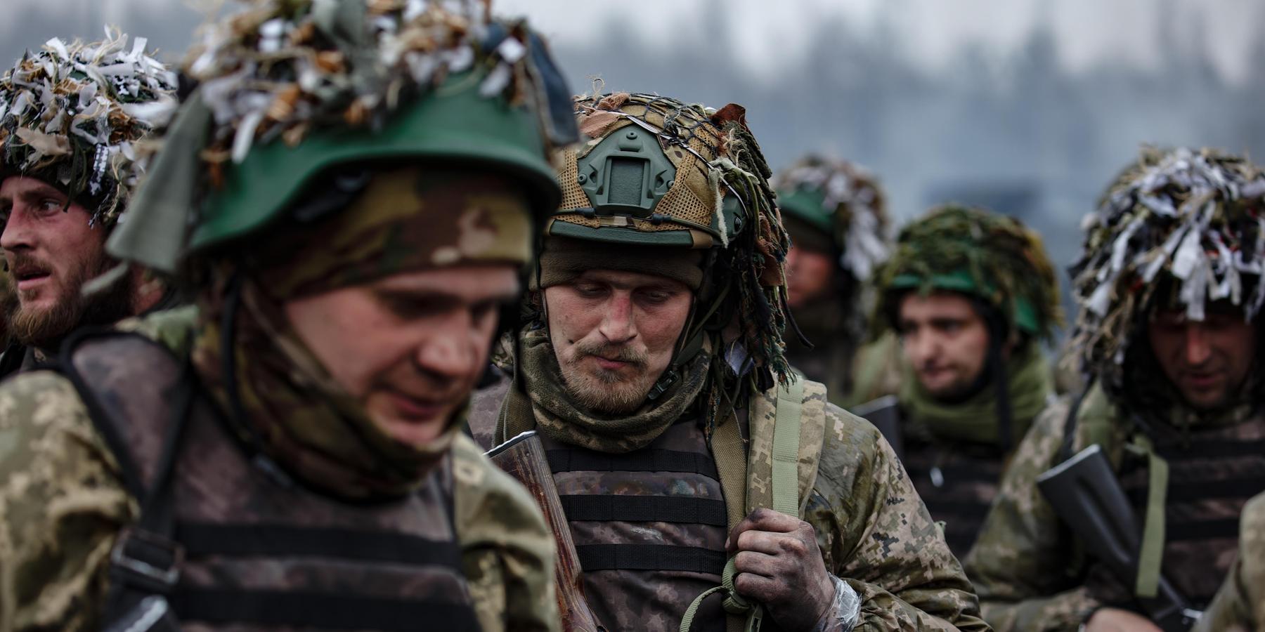 Ukrainian soldiers walk together during training for the 2023 counteroffensive.
